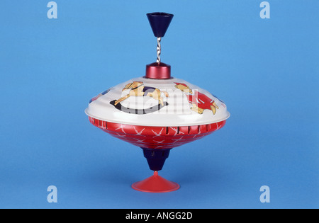 Vintage toy spinning top on blue background Stock Photo