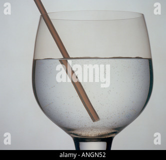 Refraction of a straw in a glass of water Stock Photo