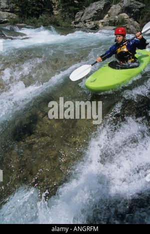 A kayaker negotiating the Elbow River in Bragg Creek, Alberta, Canada Stock Photo