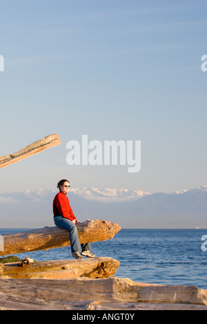 A woman enjoying the view along the Dallas Road waterfront in Victoria, Vancouver Island, British Columbia, Canada. Stock Photo