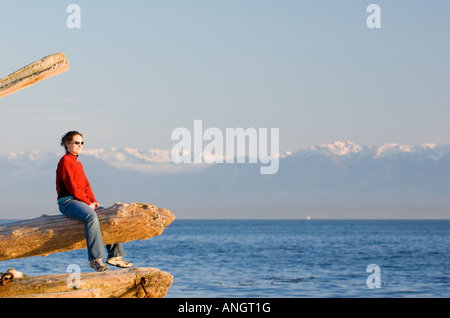 A woman enjoying the view along the Dallas Road waterfront in Victoria, Vancouver Island, British Columbia, Canada. Stock Photo