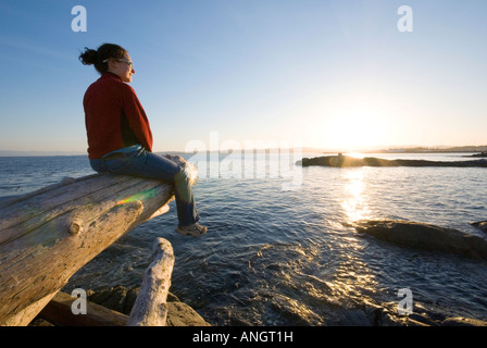 A woman enjoying the view along the Dallas Road waterfront in Victoria, Vancouver Island, British Columbia, Canada. Stock Photo