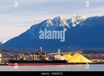 Ship at Vancouver Wharves/sulfur pile, Vancouver, British Columbia, Canada. Stock Photo