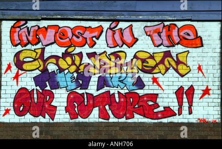 Graffiti wall art Invest in the children they are our future Hulme Manchester North West UK Europe Stock Photo