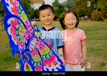 A girl and boy  in the park play kite. Stock Photo