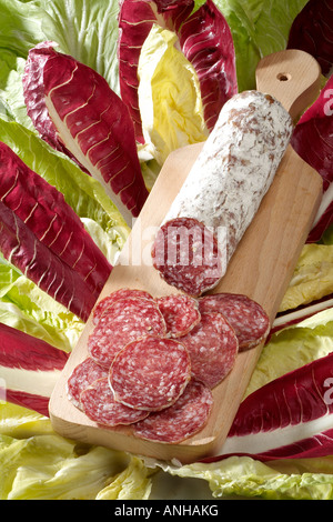 sliced salami on cutting board Stock Photo