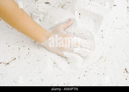 Child playing in sand, cropped view of hand Stock Photo