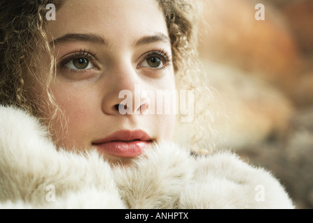 Teen girl under soft blanket, close-up Stock Photo