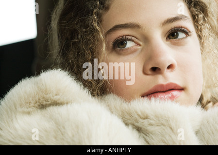 Teen girl under soft blanket, close-up Stock Photo