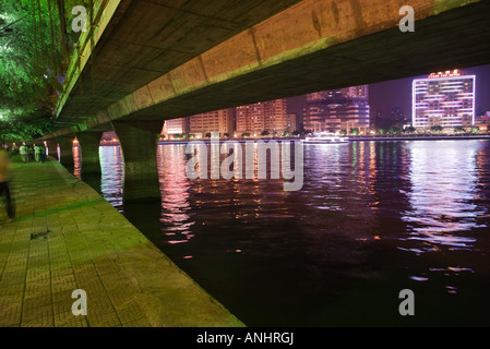 Overpass viewed from riverside quay at night, low angle view Stock Photo