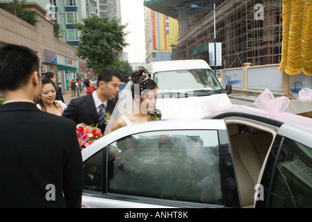 Bride and groom getting in to car Stock Photo