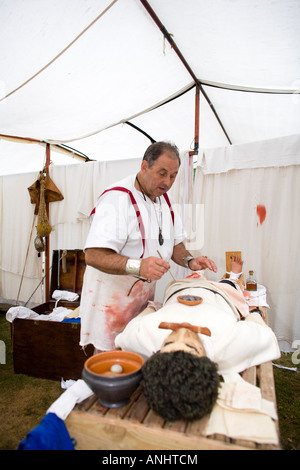 A reenactor dressed as a Roman surgeon or doctor at Chedworth Villa, Gloucestershire, UK Stock Photo