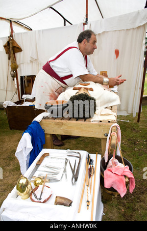 A reenactor dressed as a Roman surgeon or doctor at Chedworth Villa, Gloucestershire, UK Stock Photo