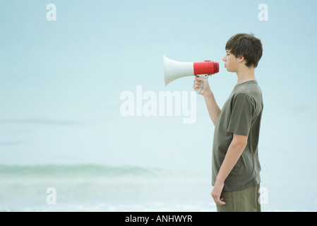 Boy using megaphone, side view Stock Photo