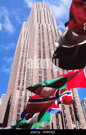 New York City Rockefeller Center (The Comcast Building) (30 Rockefeller Center) and international flags flying around the skating rink.USA Stock Photo