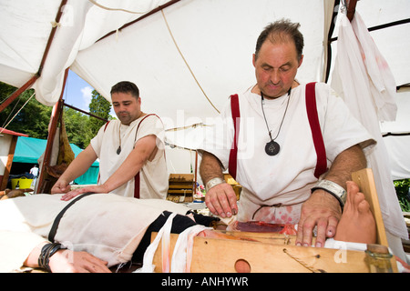 Reenactor dressed as Roman surgeons or doctors at Chedworth Villa, Gloucestershire, UK Stock Photo