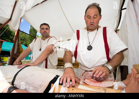 Reenactor dressed as Roman surgeons or doctors at Chedworth Villa, Gloucestershire, UK Stock Photo