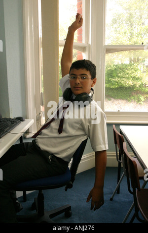 Boy, pupil with hand up in lesson. Dyslexic unit Brighton College Stock Photo