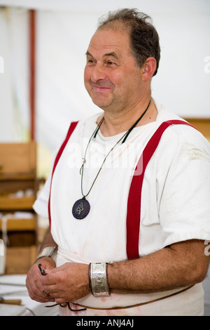 A reenactor dressed as a Roman surgeon or doctor at Chedworth Villa, Gloucestershire, UK Stock Photo