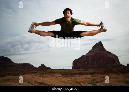 Young Asian man doing a split in mid air Stock Photo