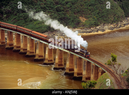 THE OUTENIQUA CHOO TJOE Class 19D steam locomotive Tootsie crossing Kaaimans River Bridge Wilderness Western Cape South Africa Stock Photo