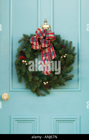 christmas wreath hung on a blue door Stock Photo