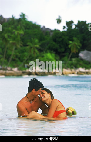 Couple in waters off La Digue Island in Seychelles Stock Photo