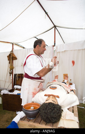 A reenactor dressed as a Roman surgeon or doctor at Chedworth Villa, Gloucestershire, UK Stock Photo