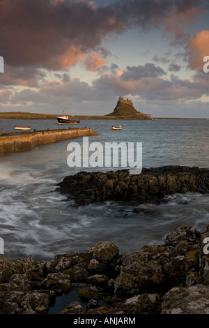View from the harbour towards Lindisfarne Castle on Holy Island in Northumberland Stock Photo
