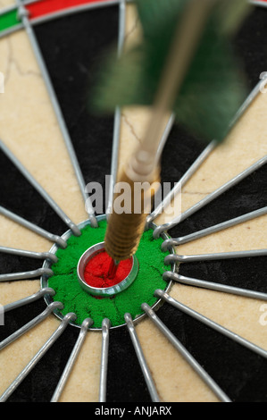 Dart in bullseye of dartboard Stock Photo