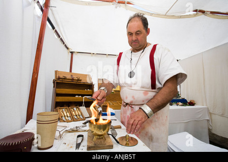 A reenactor dressed as a Roman surgeon or doctor at Chedworth Villa, Gloucestershire, UK Stock Photo