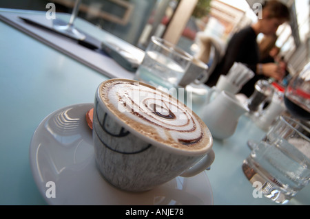 cup of cappucino coffee on a restaurant table Stock Photo
