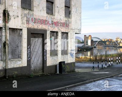 Derelict pub with Sage Music Centre Millenium bridge etc in background Tyneside UK Stock Photo