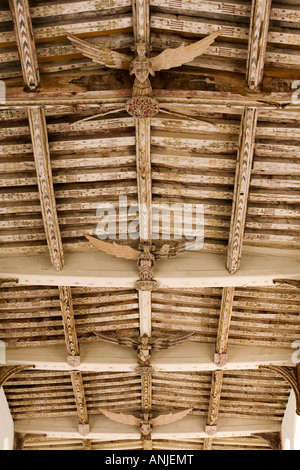 UK Suffolk Blythburgh village All Saints Church medieval carved wooden angel roof bosses amongst painted ceiling Stock Photo