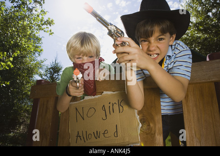 Two boys playing cops and robbers Stock Photo - Alamy