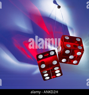 Two red transparent dice hanging on the nail Stock Photo