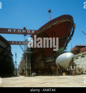 Korea,Hyundai shipyards atUlsan nrPusan.The building of two new ships sit side by side in the dry dock.Founded by Chung ju Yung. Stock Photo