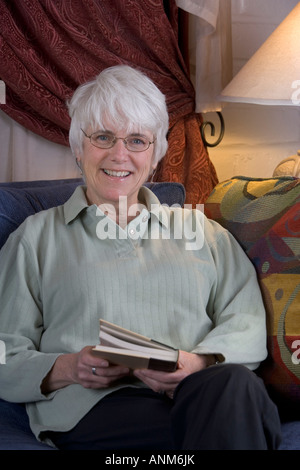 Senior woman reading a book Stock Photo - Alamy