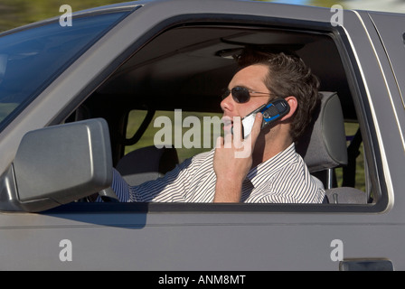 A man talking on a cell phone while driving Stock Photo