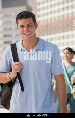 Young man carrying backpack Stock Photo