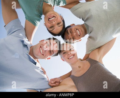 Multi-ethnic friends in huddle Stock Photo