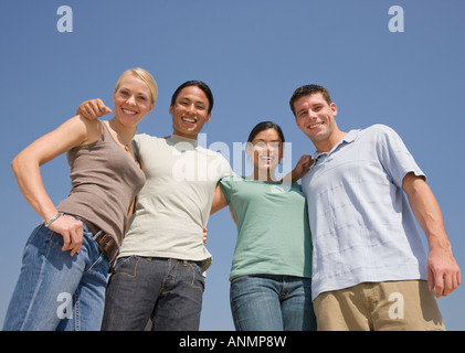 Multi-ethnic friends arm in arm Stock Photo