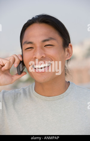 Asian man talking on cell phone Stock Photo