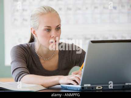 Female college student typing on laptop Stock Photo