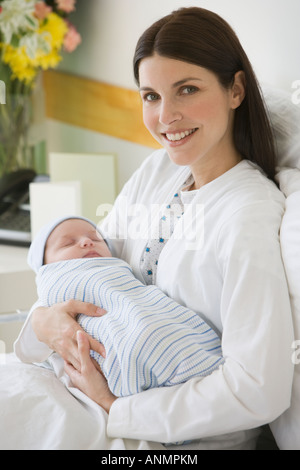 Mother Holding Newborn in Hospital Bed Stock Photo - Alamy