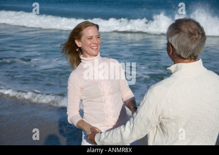 Couple holding hands at beach Stock Photo