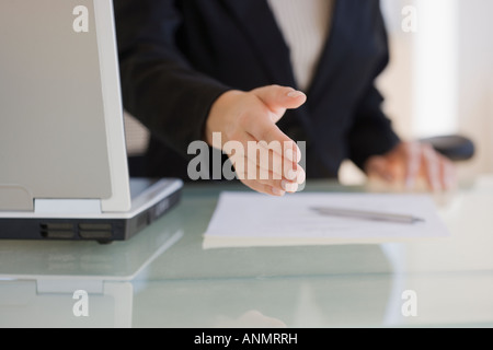 Businesswoman extending hand to shake Stock Photo