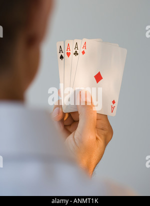 Man holding four aces Stock Photo