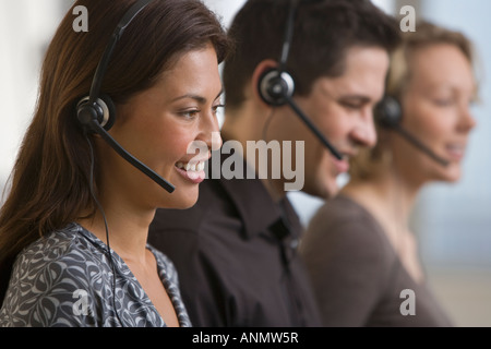 Multi-ethnic businesspeople wearing headsets Stock Photo