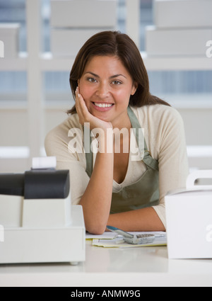 Hispanic bakery worker behind counter Stock Photo